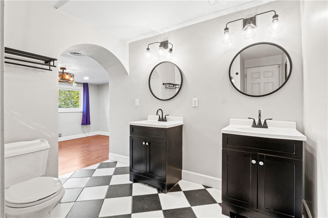 4073 Cedar Street Riverside, CA 92501 - Photo 36 of 46 a bathroom with a toilet a sink and mirror