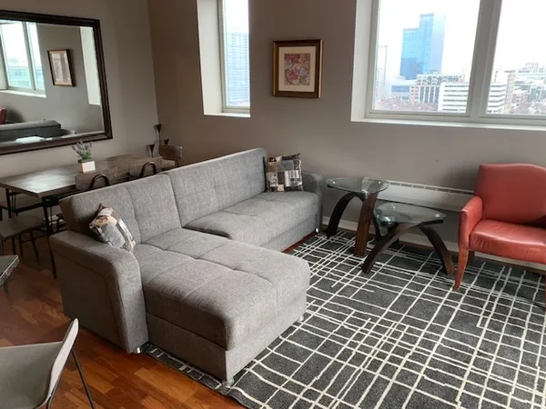 a living room with furniture and a flat screen tv