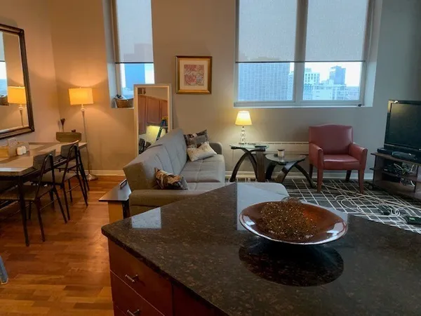 a kitchen with granite countertop a sink stove and refrigerator