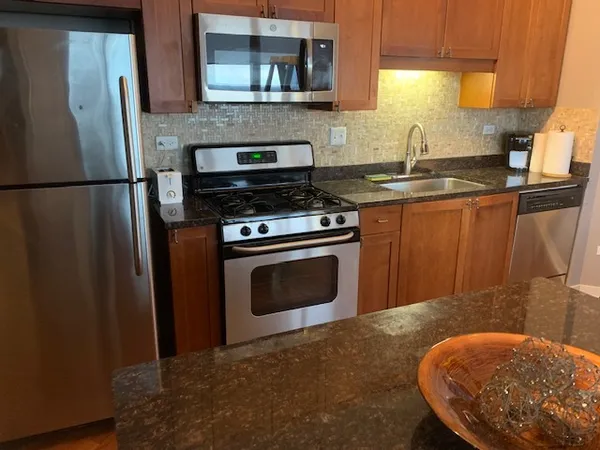 a bedroom with a bed and a flat tv screen on a dresser