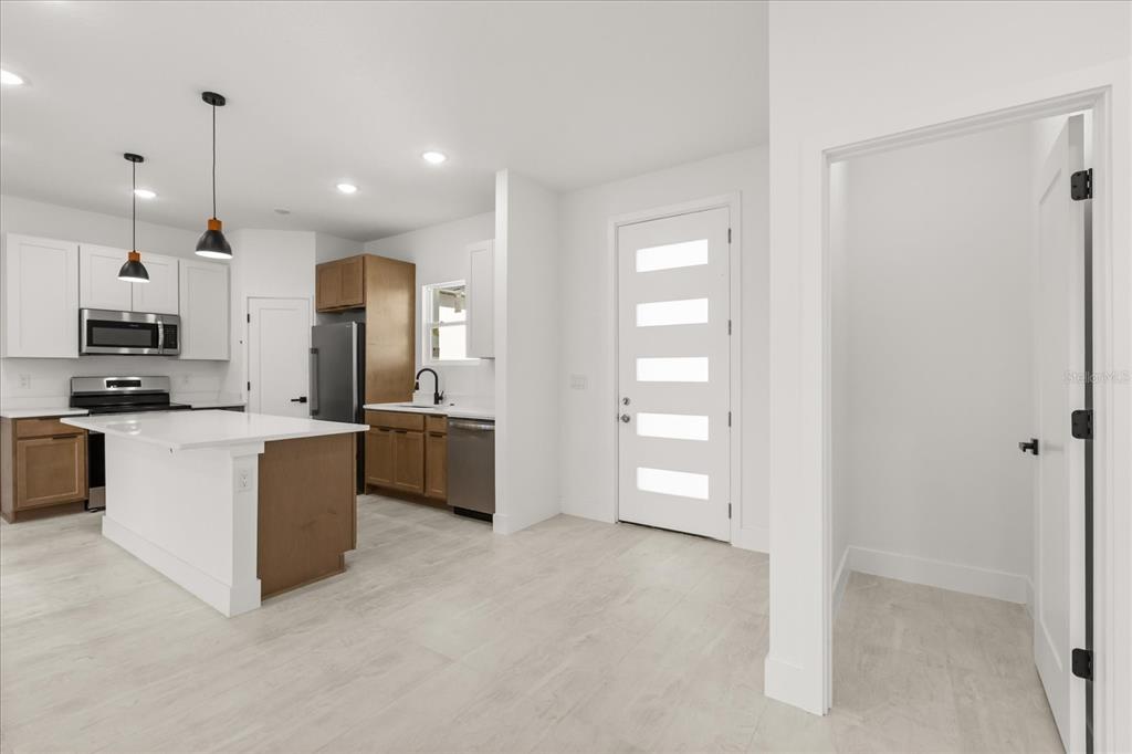 6168 Southwest 154th Street Ocala, FL 34473 - Photo 16 of 33 a large kitchen with cabinets and stainless steel appliances