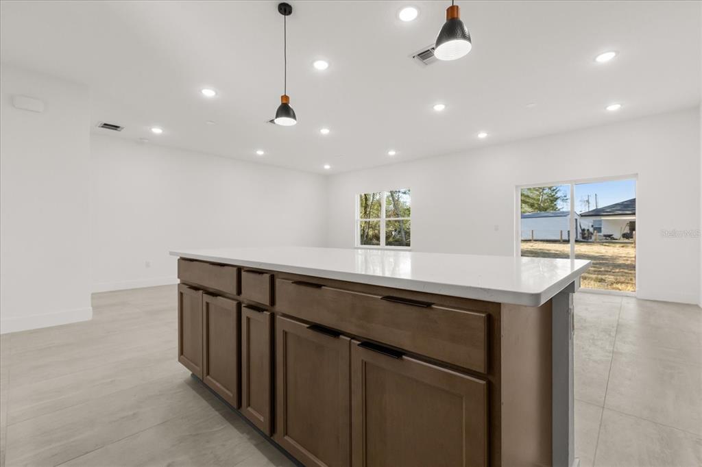 6168 Southwest 154th Street Ocala, FL 34473 - Photo 17 of 33 a kitchen with kitchen island a sink stainless steel appliances and window