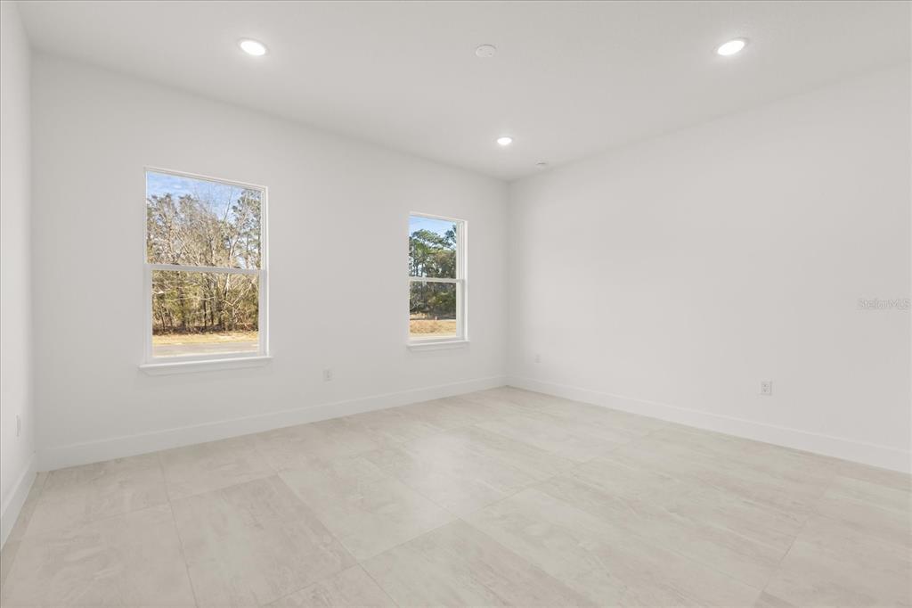 6168 Southwest 154th Street Ocala, FL 34473 - Photo 18 of 33 an empty room with windows