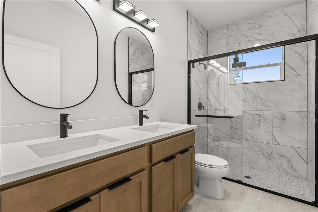 6168 Southwest 154th Street Ocala, FL 34473 - Photo 21 of 33 a bathroom with a toilet a sink and mirror