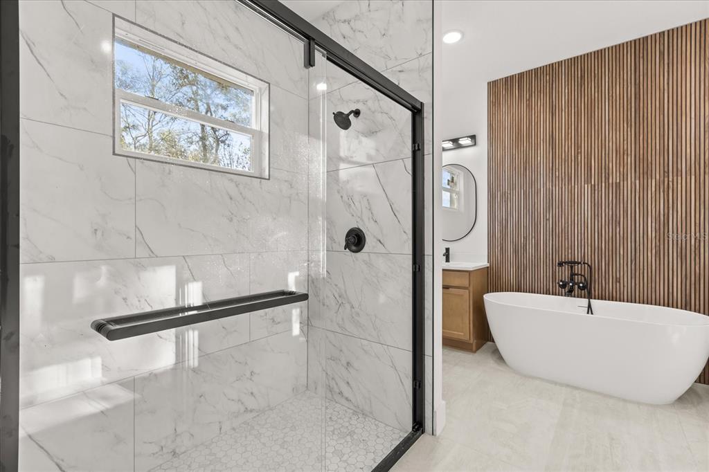 6168 Southwest 154th Street Ocala, FL 34473 - Photo 3 of 33 a bathroom with a tub and a shower