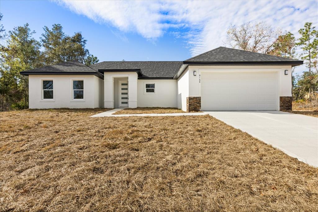 6168 Southwest 154th Street Ocala, FL 34473 - Photo 8 of 33 a front view of a house with a yard