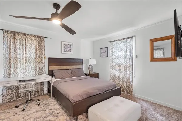 a bedroom with a large bed and a chandelier