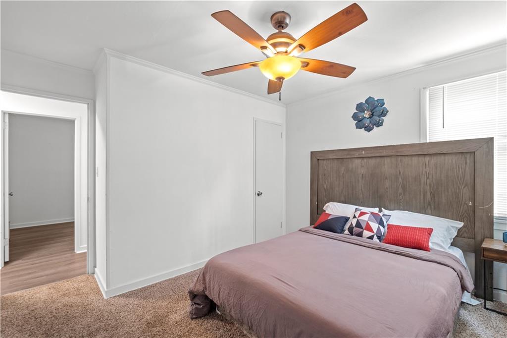 1738 Duke Road Atlanta, GA 30341 - Photo 18 of 23 a bedroom with a bed and a chandelier