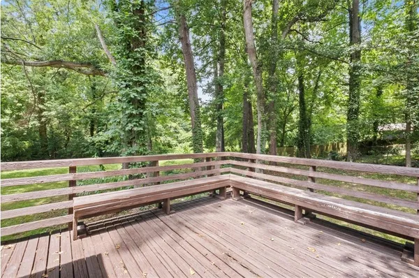 a view of backyard with deck and trees