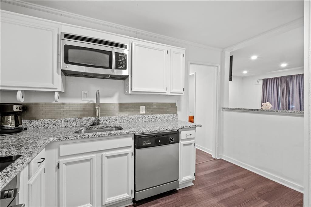 1738 Duke Road Atlanta, GA 30341 - Photo 5 of 23 a kitchen with stainless steel appliances granite countertop a sink and a stove