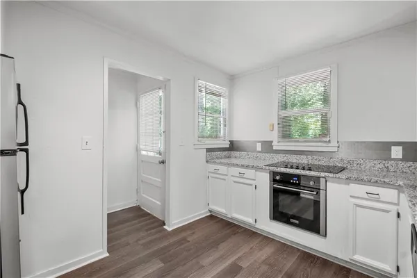 a kitchen with a stove a sink and a refrigerator
