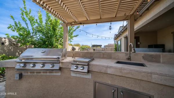 a table and chairs sitting in backyard of a house