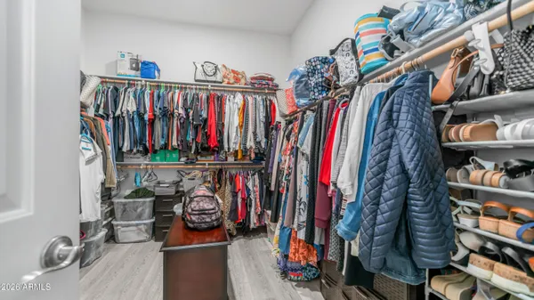 a view of walk in closet with clothes