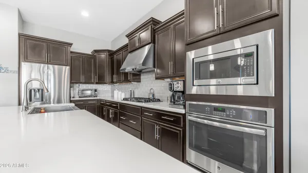 a kitchen with stainless steel appliances granite countertop a stove and a sink