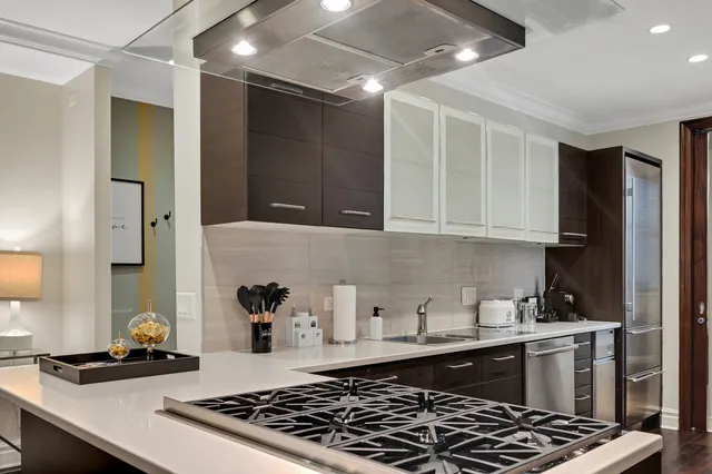 a kitchen with sink a stove and cabinets