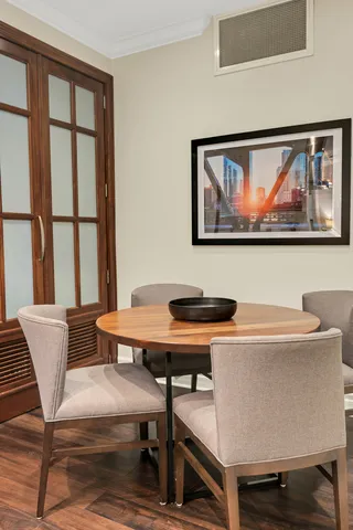 a view of a workspace with furniture and a window