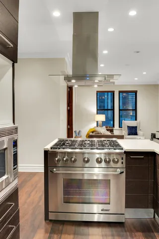 a stove top oven sitting inside of a kitchen