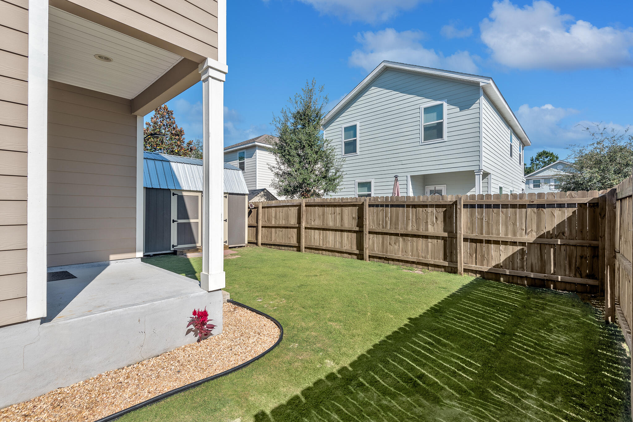 107 Mosaic Oaks Circle Santa Rosa Beach, FL 32459 - Photo 13 of 46 a view of backyard with garden and deck