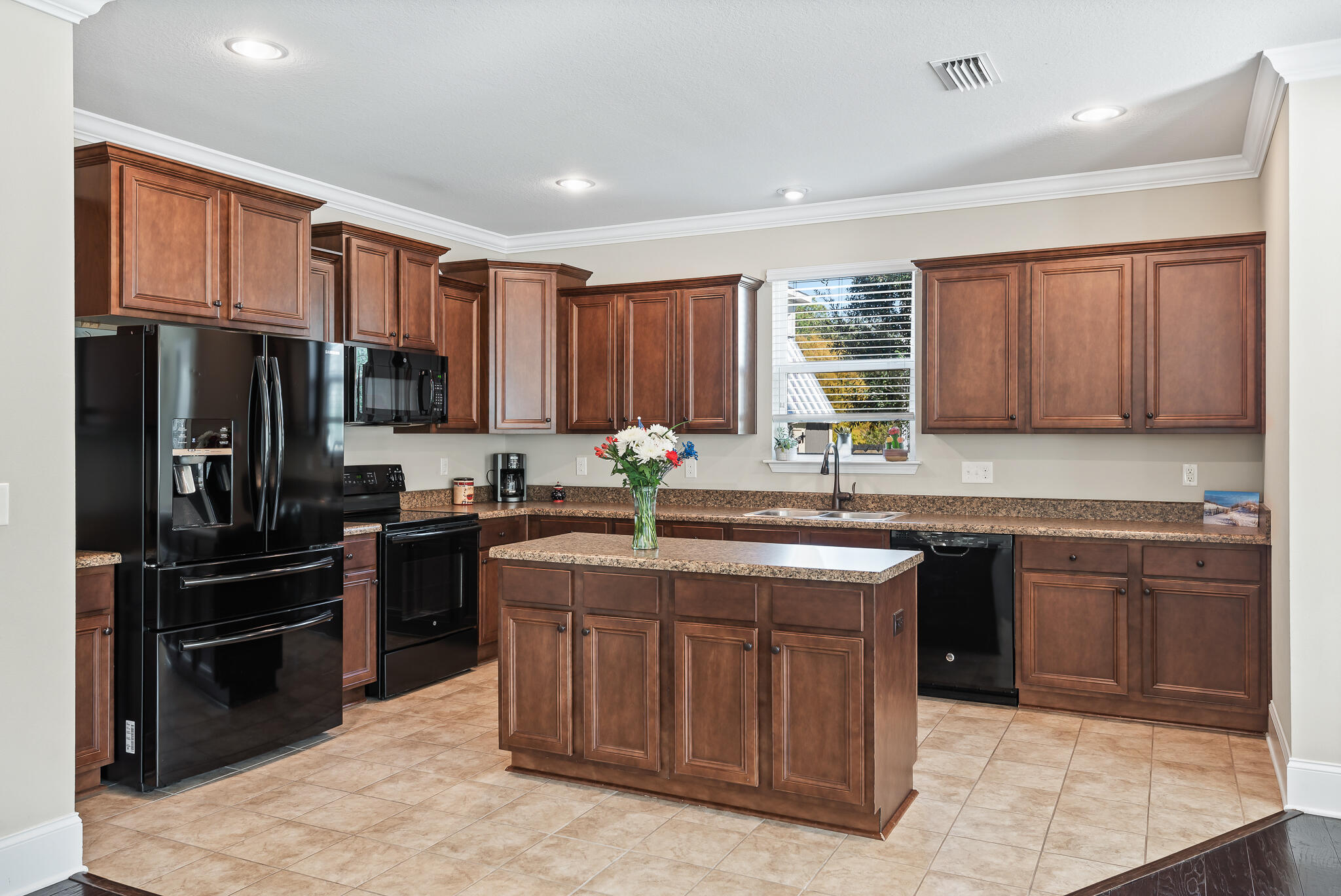 107 Mosaic Oaks Circle Santa Rosa Beach, FL 32459 - Photo 19 of 46 a kitchen with kitchen island granite countertop a stove sink and refrigerator