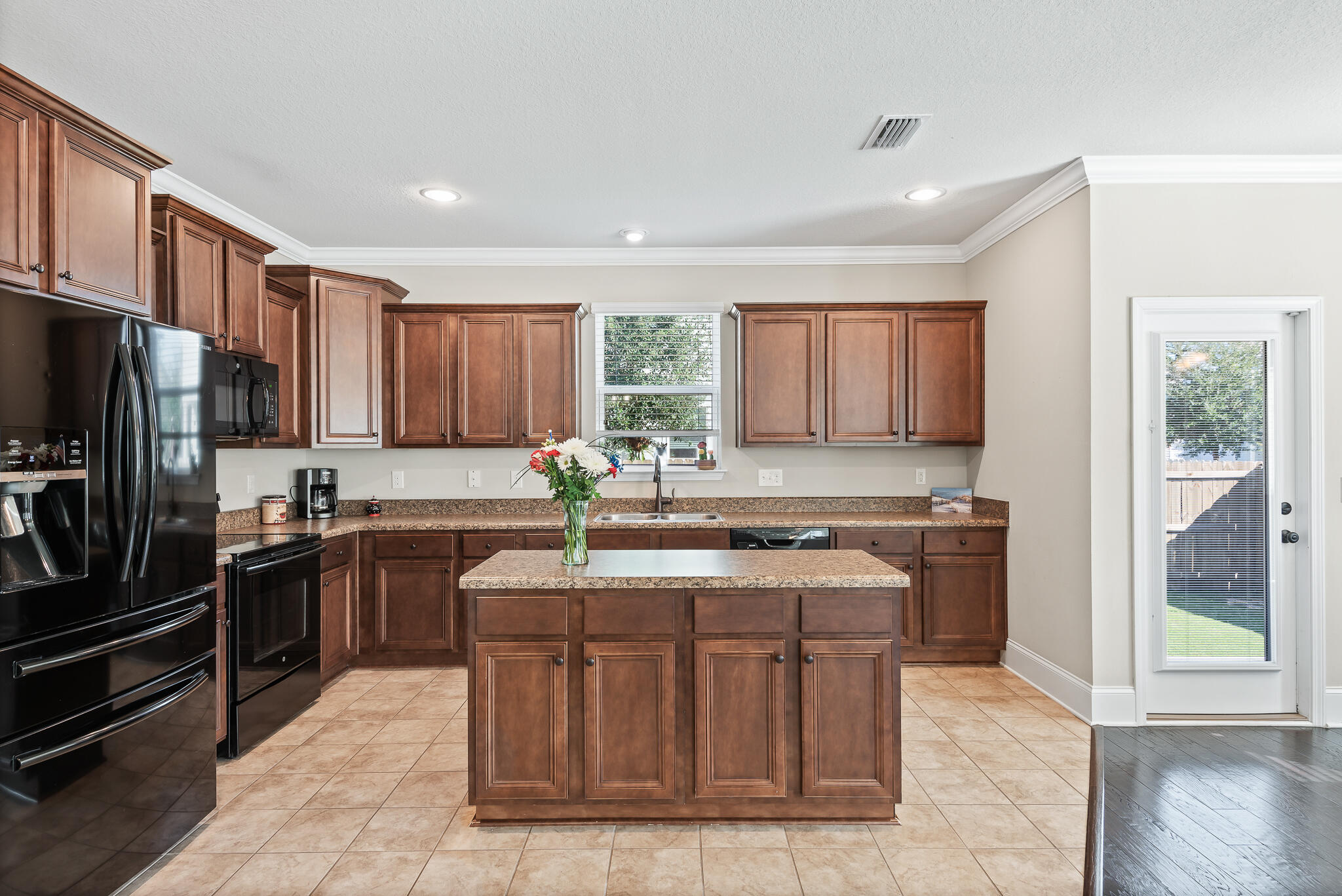 107 Mosaic Oaks Circle Santa Rosa Beach, FL 32459 - Photo 20 of 46 a kitchen with stainless steel appliances granite countertop a stove a sink dishwasher a refrigerator and a oven with wooden floor