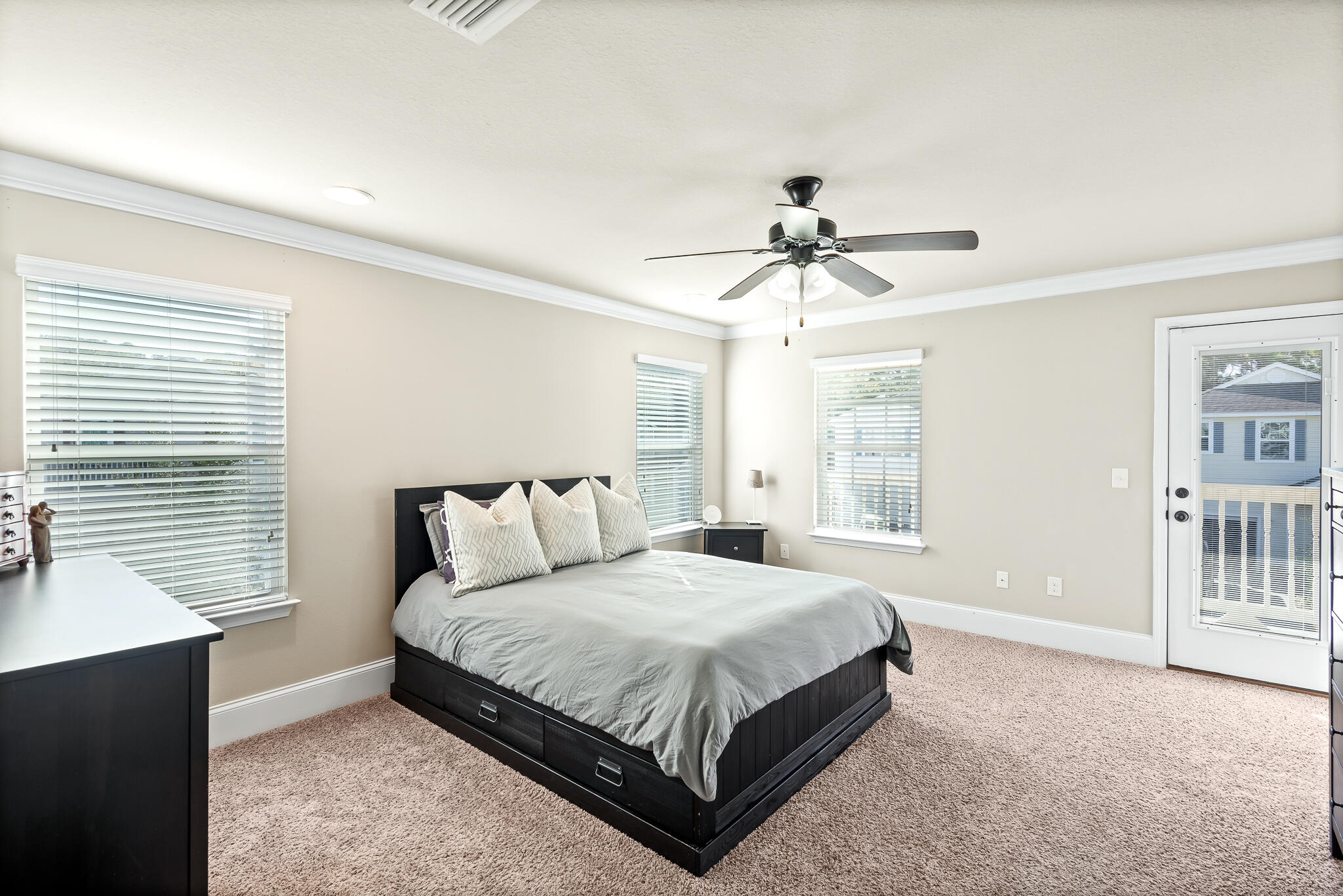 107 Mosaic Oaks Circle Santa Rosa Beach, FL 32459 - Photo 27 of 46 a spacious bedroom with a bed and a chandelier