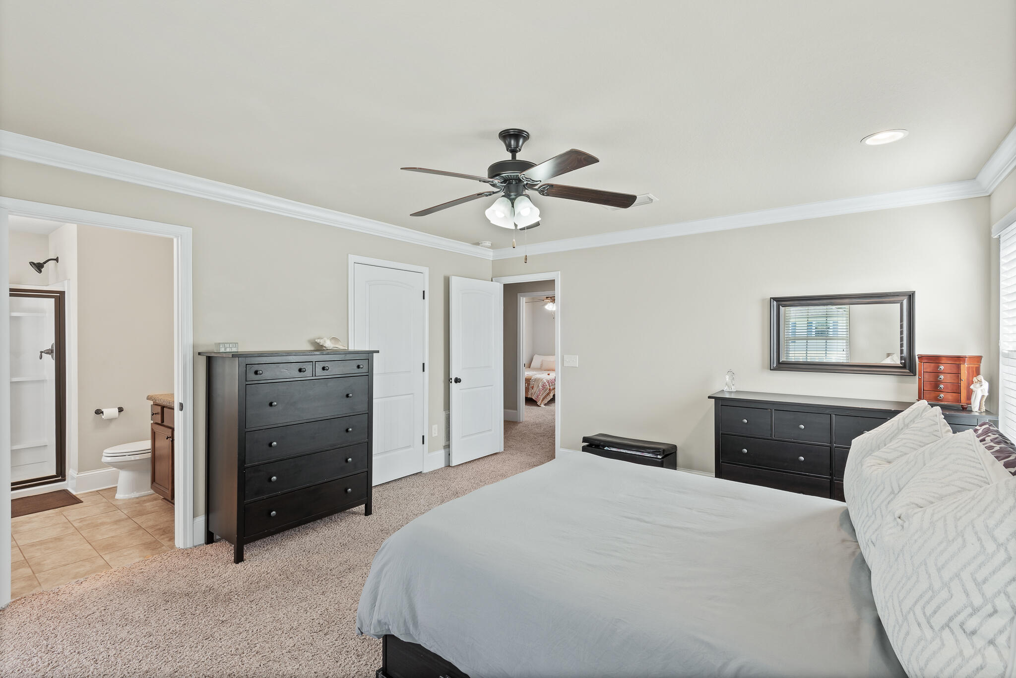 107 Mosaic Oaks Circle Santa Rosa Beach, FL 32459 - Photo 30 of 46 a bedroom with a bed and a chandelier