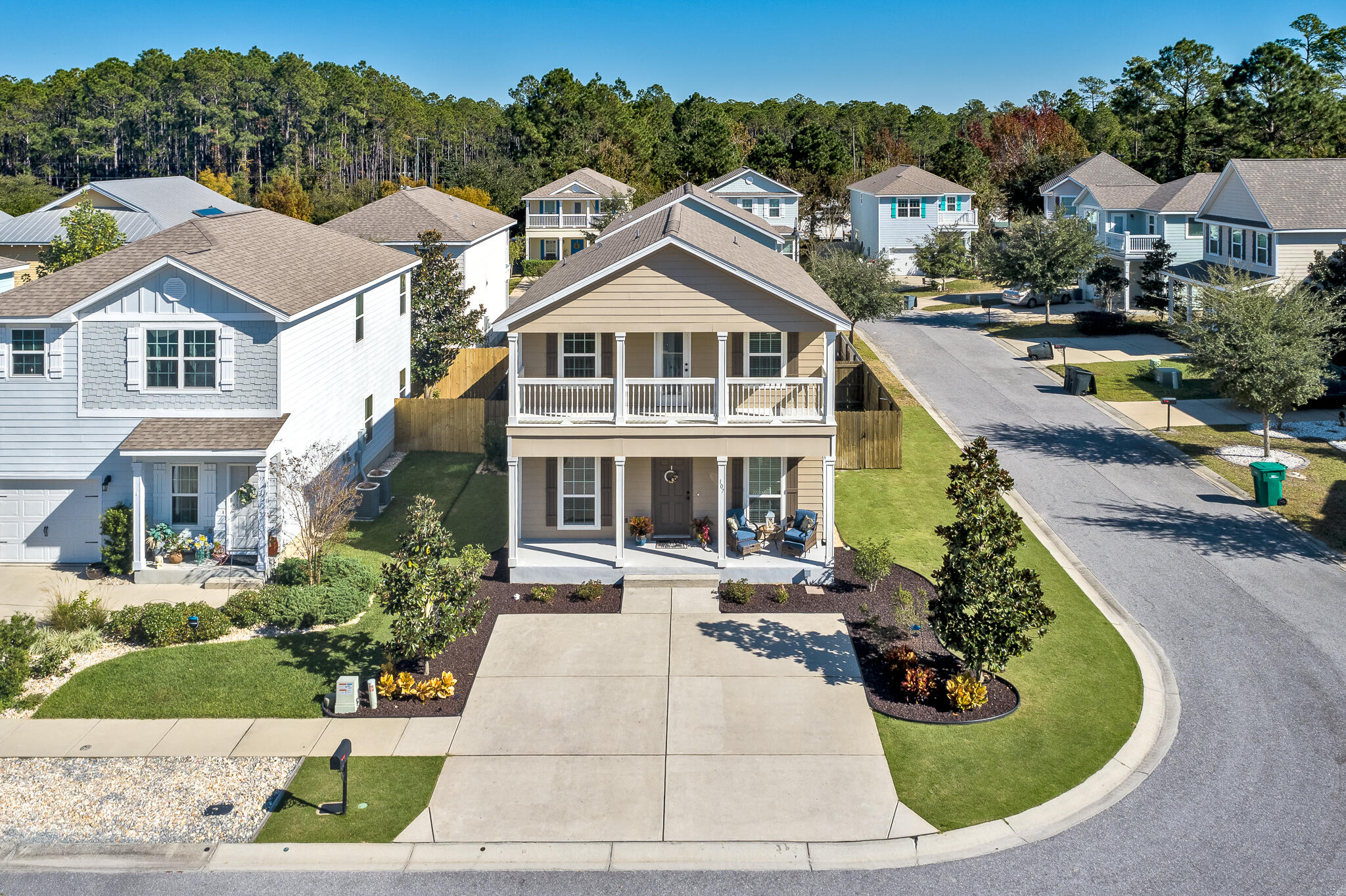 107 Mosaic Oaks Circle Santa Rosa Beach, FL 32459 - Photo 7 of 46 a view of a white house with a small yard and potted plants
