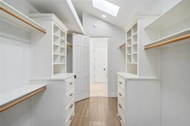walk in closet with white walls and window