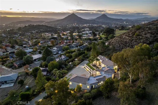 an aerial view of residential houses with outdoor space and mountain view