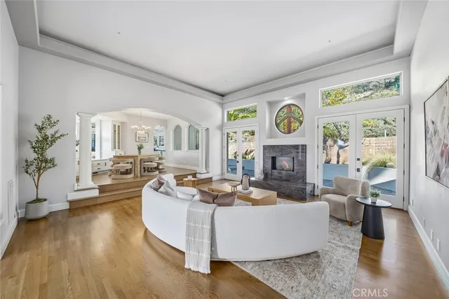 a living room with fireplace furniture and a large window