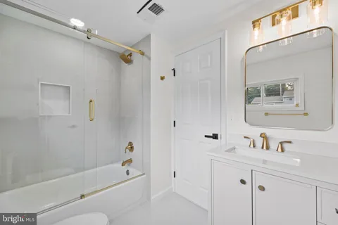 a bathroom with a shower a sink and a mirror