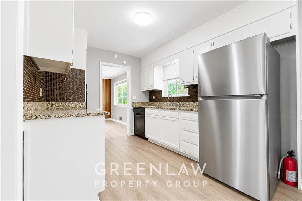 3605 Flat Shoals Road Atlanta, GA 30349 - Photo 16 of 35 a kitchen with a refrigerator and a stove top oven