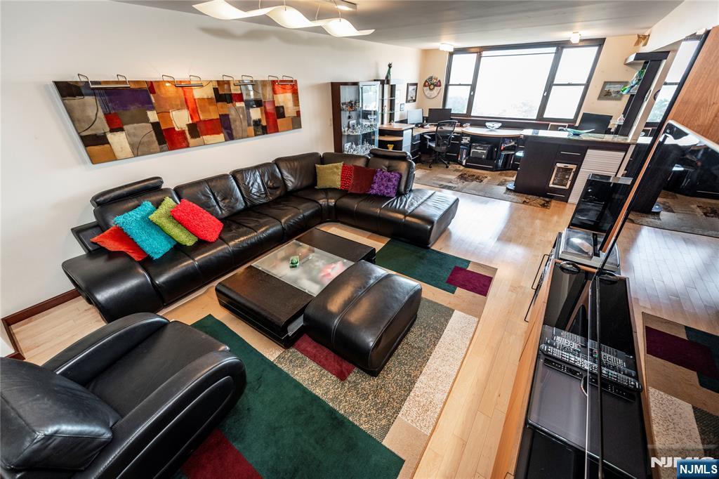 250 Gorge Road, Unit 8C Cliffside Park, NJ 07010 - Photo 18 of 43 a living room with furniture and a floor to ceiling window