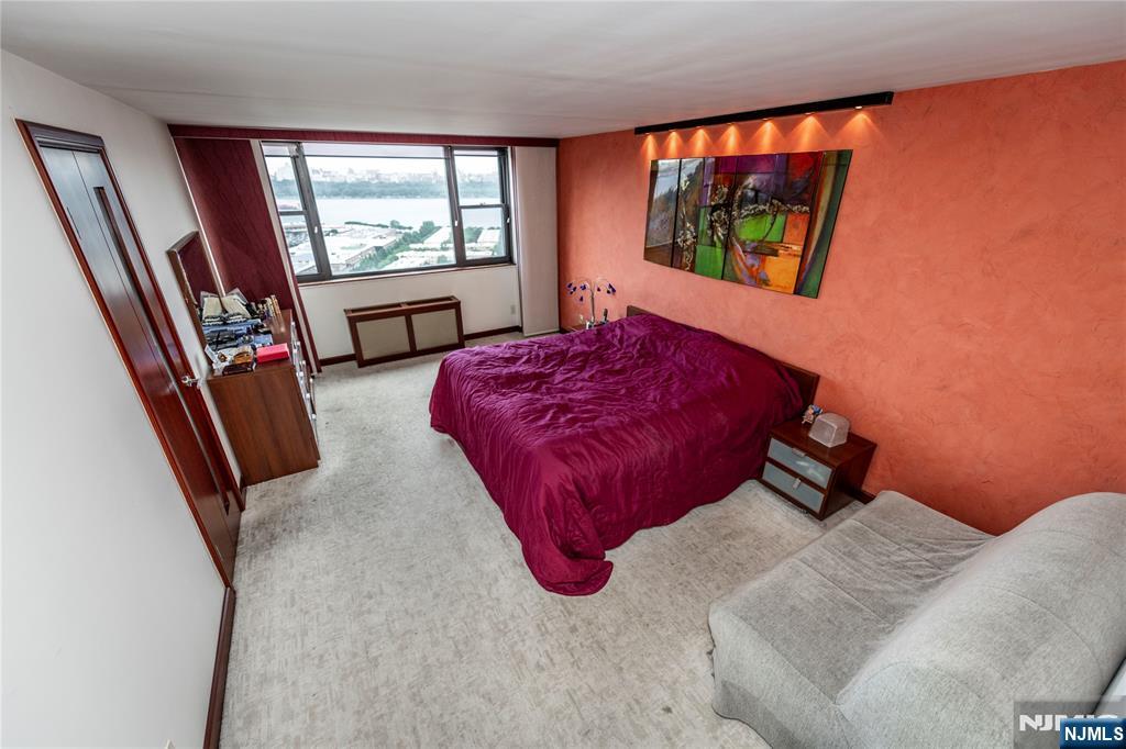 250 Gorge Road, Unit 8C Cliffside Park, NJ 07010 - Photo 24 of 43 a bedroom with a large bed and a large window