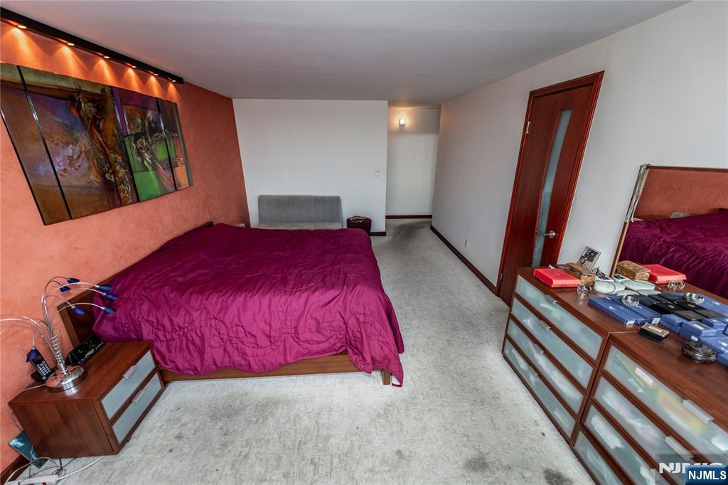 250 Gorge Road, Unit 8C Cliffside Park, NJ 07010 - Photo 26 of 43 a bedroom with a bed and a dresser next to a window