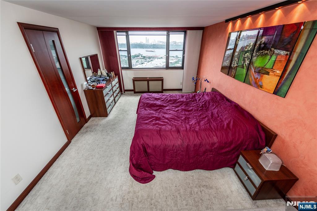 250 Gorge Road, Unit 8C Cliffside Park, NJ 07010 - Photo 27 of 43 a bed sitting in a bedroom next to a window