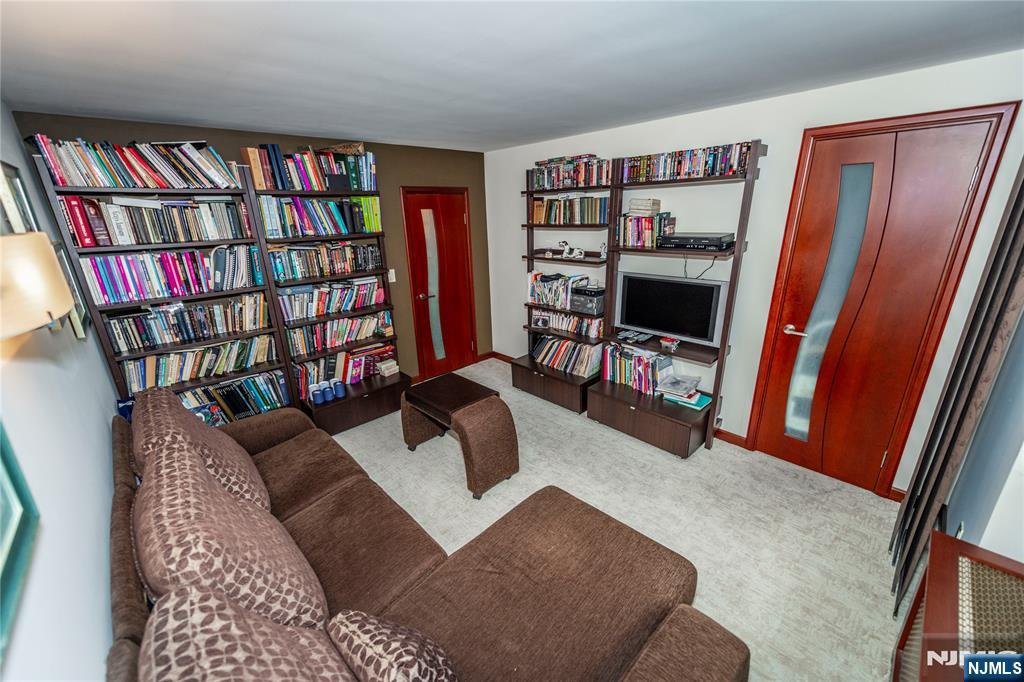 250 Gorge Road, Unit 8C Cliffside Park, NJ 07010 - Photo 31 of 43 a living room with furniture and a book shelf