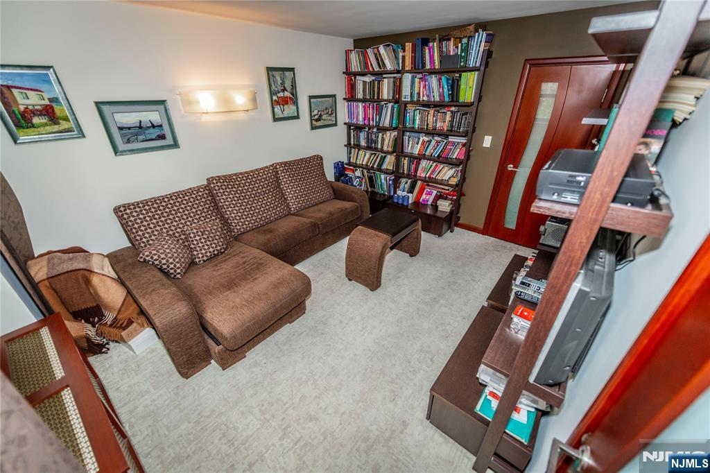 250 Gorge Road, Unit 8C Cliffside Park, NJ 07010 - Photo 32 of 43 a living room with furniture and a book shelf
