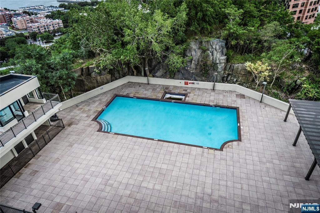 250 Gorge Road, Unit 8C Cliffside Park, NJ 07010 - Photo 36 of 43 a backyard of a house with lawn chairs plants and trees