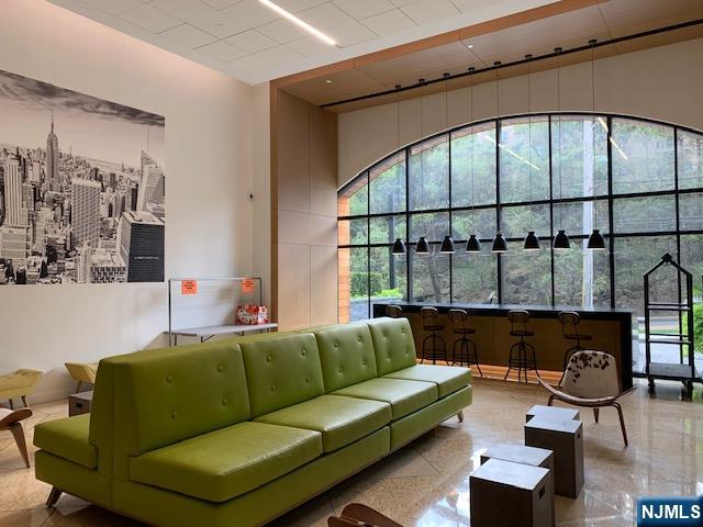 250 Gorge Road, Unit 8C Cliffside Park, NJ 07010 - Photo 37 of 43 a living room with furniture and a floor to ceiling window