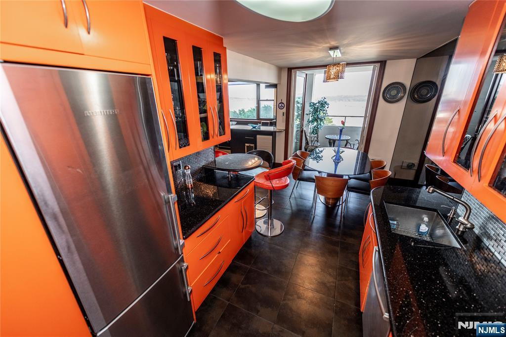 250 Gorge Road, Unit 8C Cliffside Park, NJ 07010 - Photo 8 of 43 a view of a kitchen with furniture and a refrigerator