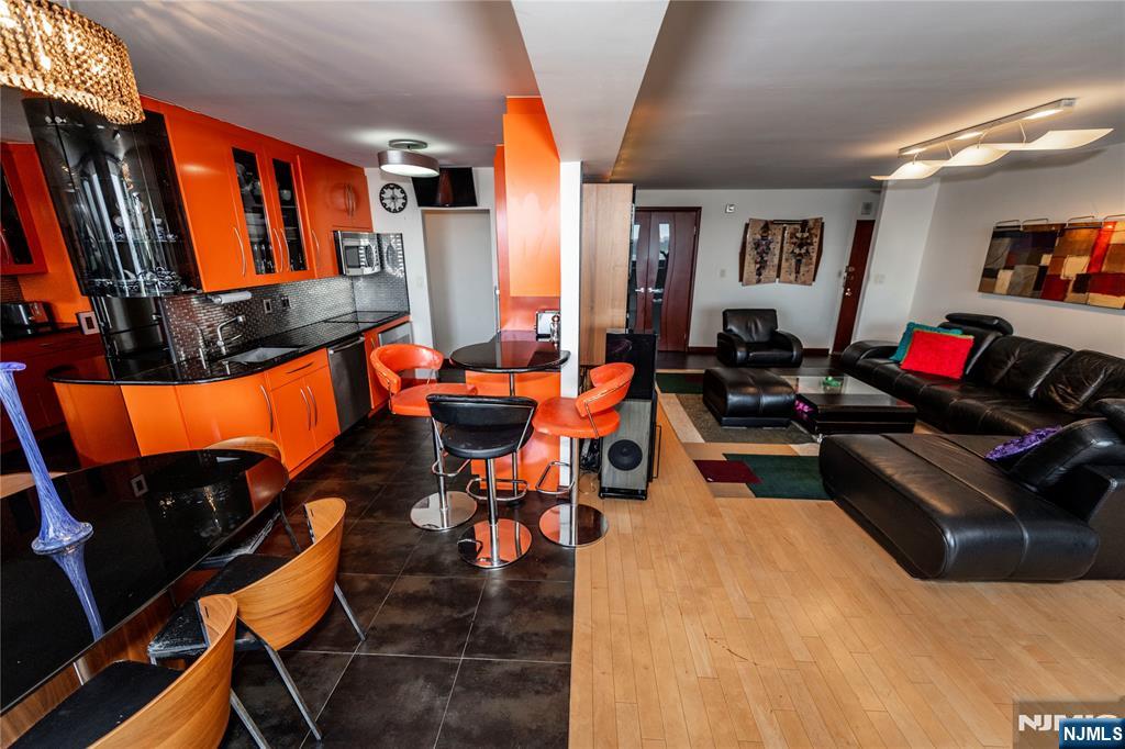 250 Gorge Road, Unit 8C Cliffside Park, NJ 07010 - Photo 10 of 43 a living room with furniture and a flat screen tv