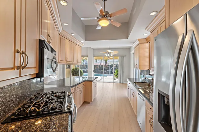 a kitchen with stainless steel appliances a stove a refrigerator and furniture