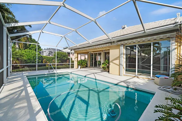 a view of a house with backyard porch and sitting area