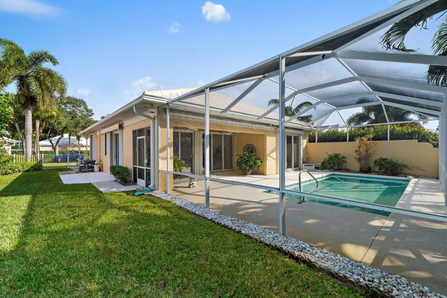 a view of a house with a yard and potted plants