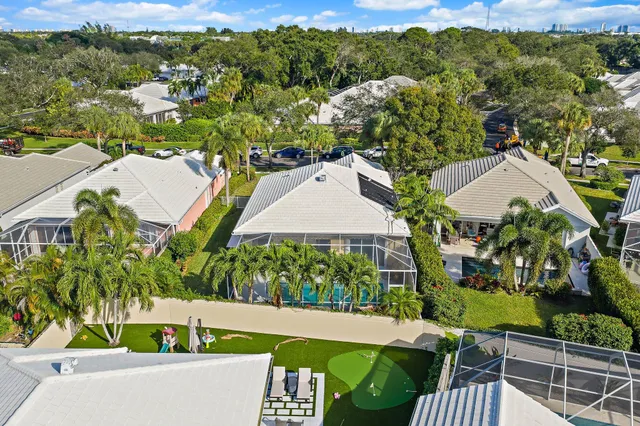 an aerial view of residential houses with outdoor space and trees