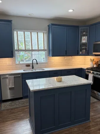 a kitchen with a sink window and cabinets