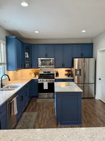 a kitchen with wooden cabinets and stainless steel appliances