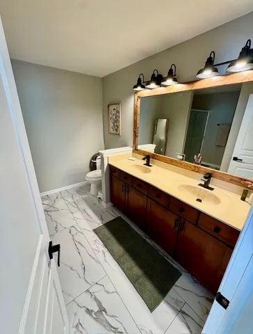 a bed room with a bed and a view of kitchen