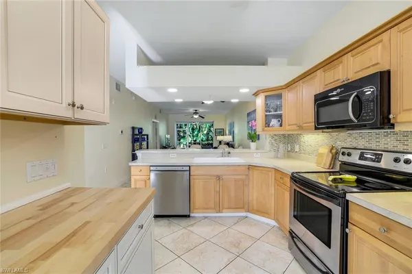 a kitchen with a sink stainless steel appliances and cabinets